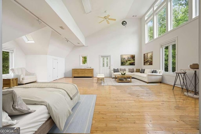 326 Seldom Seen Trl, Canton, GA 30115 - bedroom featuring hardwood / wood-style flooring, a skylight, rail lighting, and high vaulted ceiling