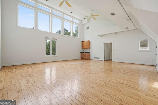 326 Seldom Seen Trl, Canton, GA 30115 - unfurnished living room with a ceiling fan, light wood-style flooring, and high vaulted ceiling
