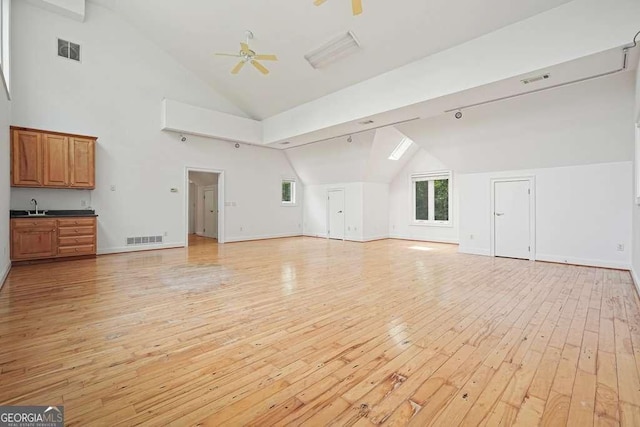 326 Seldom Seen Trl, Canton, GA 30115 - unfurnished living room featuring vaulted ceiling, light wood-style floors, and a ceiling fan