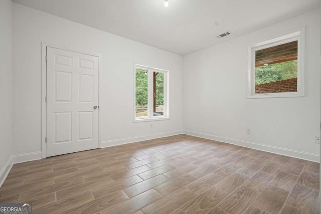 326 Seldom Seen Trl, Canton, GA 30115 - empty room featuring plenty of natural light and light wood-style flooring