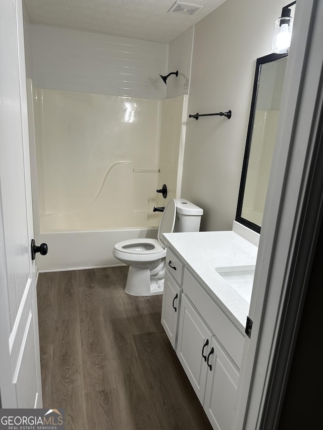 140 Clover Valley Dr, Covington, GA 30016 - full bath featuring toilet, vanity, wood finished floors, and shower / bath combination