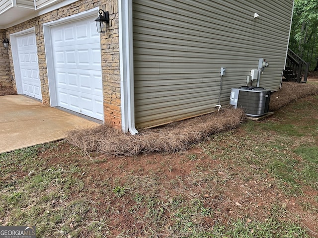 140 Clover Valley Dr, Covington, GA 30016 - garage featuring concrete driveway and central air condition unit