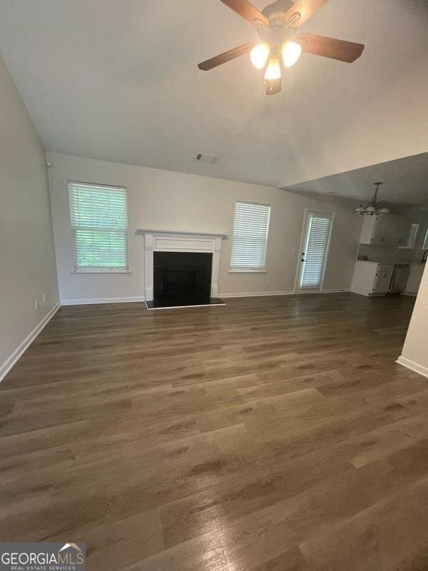 140 Clover Valley Dr, Covington, GA 30016 - unfurnished living room with baseboards, a fireplace, a ceiling fan, and wood finished floors