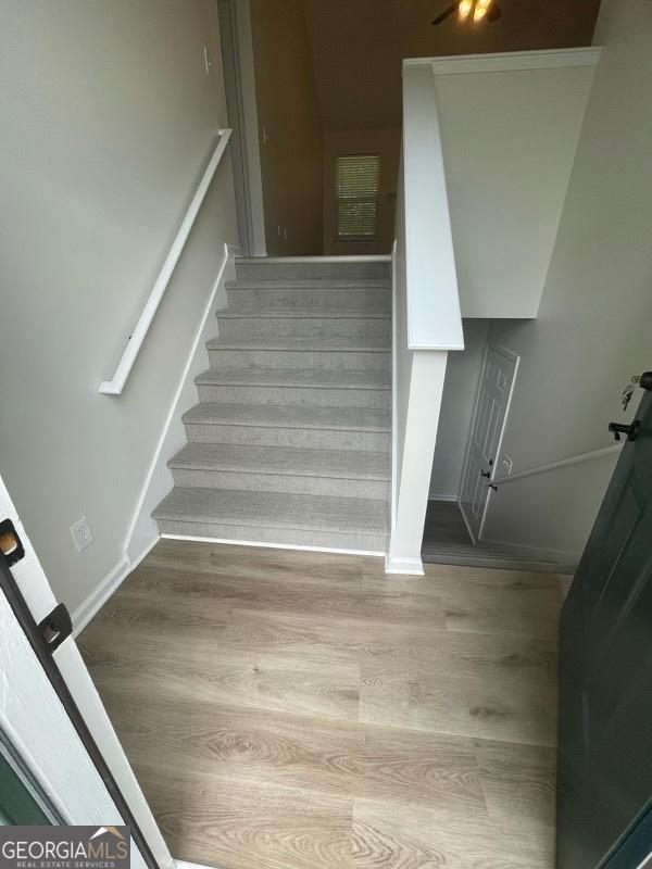 140 Clover Valley Dr, Covington, GA 30016 - stairway with wood finished floors and baseboards