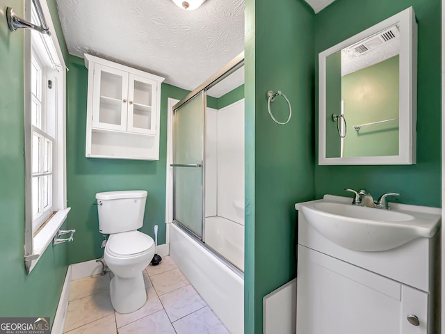 927 Dean Patrick Rd, Locust Grove, GA 30248 - full bath with toilet, vanity, combined bath / shower with glass door, a textured ceiling, and baseboards
