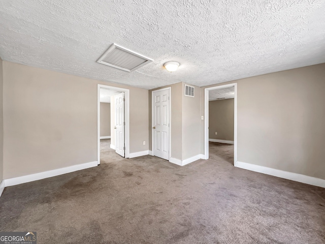927 Dean Patrick Rd, Locust Grove, GA 30248 - carpeted spare room with baseboards, a textured ceiling, and attic access