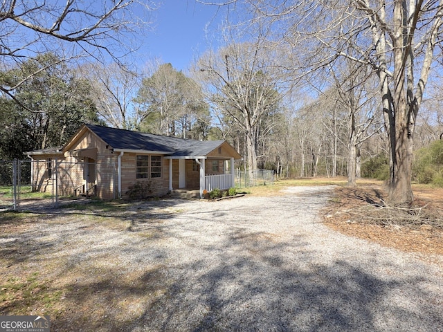 927 Dean Patrick Rd, Locust Grove, GA 30248 - view of property exterior featuring a porch and gravel driveway