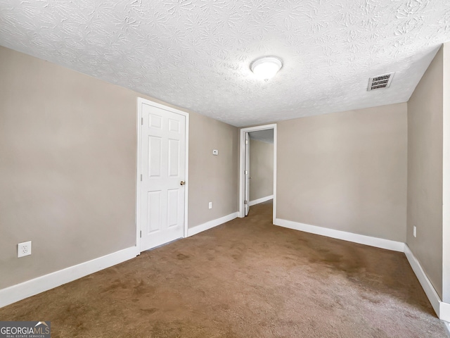 927 Dean Patrick Rd, Locust Grove, GA 30248 - unfurnished bedroom featuring carpet flooring, baseboards, and a textured ceiling