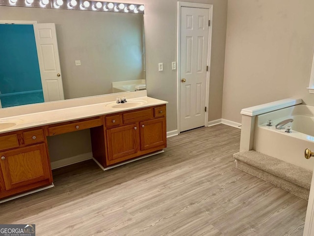 230 Wytheford Ct, Alpharetta, GA 30004 - full bath with double vanity, wood finished floors, a bath, and baseboards
