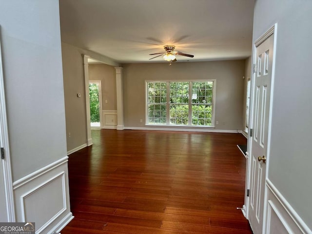 230 Wytheford Ct, Alpharetta, GA 30004 - unfurnished room featuring ceiling fan, dark wood-style flooring, decorative columns, and a wainscoted wall