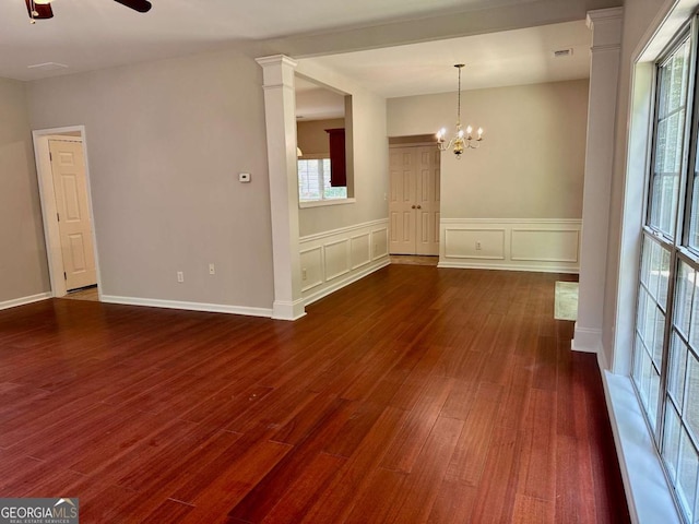 230 Wytheford Ct, Alpharetta, GA 30004 - empty room with dark wood-type flooring, healthy amount of natural light, ceiling fan, wainscoting, and a chandelier