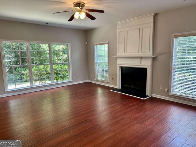 230 Wytheford Ct, Alpharetta, GA 30004 - unfurnished living room with baseboards, dark wood-type flooring, ceiling fan, and a large fireplace
