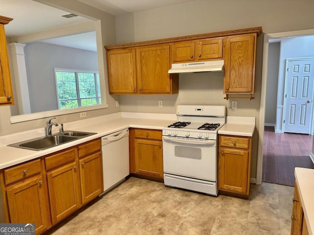 230 Wytheford Ct, Alpharetta, GA 30004 - kitchen with white appliances, under cabinet range hood, a sink, brown cabinets, and light countertops