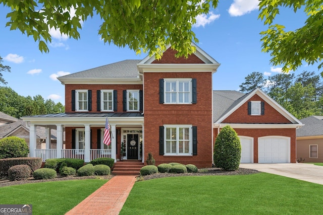 952 Moores Walk Ln, Suwanee, GA 30024 - view of front of property featuring covered porch, brick siding, concrete driveway, a front lawn, and a standing seam roof