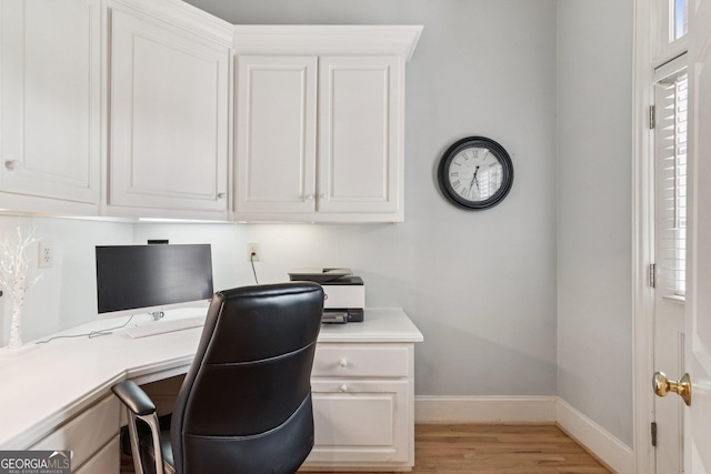 952 Moores Walk Ln, Suwanee, GA 30024 - home office with light wood-style floors, baseboards, and built in desk
