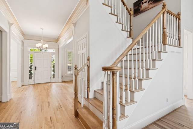 952 Moores Walk Ln, Suwanee, GA 30024 - entryway with a chandelier, wood finished floors, stairway, baseboards, and ornamental molding