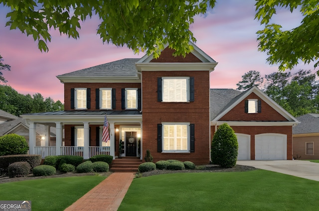 952 Moores Walk Ln, Suwanee, GA 30024 - view of front of home with a porch, brick siding, concrete driveway, a front lawn, and a shingled roof
