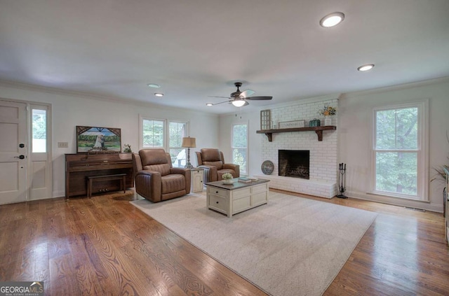 6095 Fords Rd NW, Acworth, GA 30101 - living room featuring a brick fireplace, ceiling fan, ornamental molding, wood finished floors, and recessed lighting