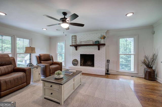 6095 Fords Rd NW, Acworth, GA 30101 - living area with plenty of natural light, crown molding, ceiling fan, light wood finished floors, and recessed lighting