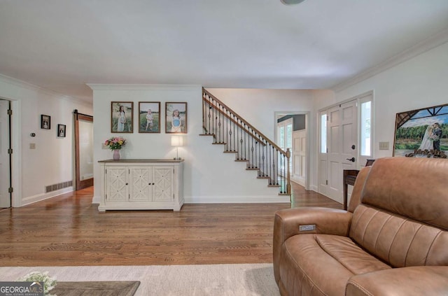 6095 Fords Rd NW, Acworth, GA 30101 - entrance foyer featuring wood finished floors, ornamental molding, stairs, and baseboards