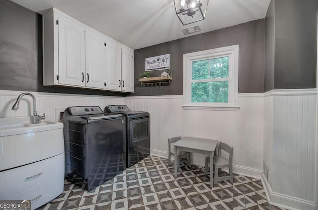6095 Fords Rd NW, Acworth, GA 30101 - laundry room with cabinet space, separate washer and dryer, a wainscoted wall, and light flooring