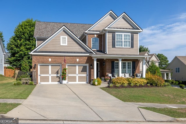7891 Brass Lantern Dr, Flowery Branch, GA 30542 - view of front of home with driveway, brick siding, a porch, a standing seam roof, and roof with shingles