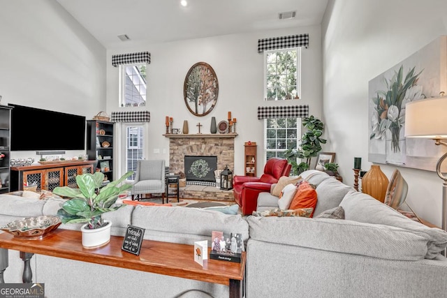 7891 Brass Lantern Dr, Flowery Branch, GA 30542 - living room featuring a fireplace and a towering ceiling