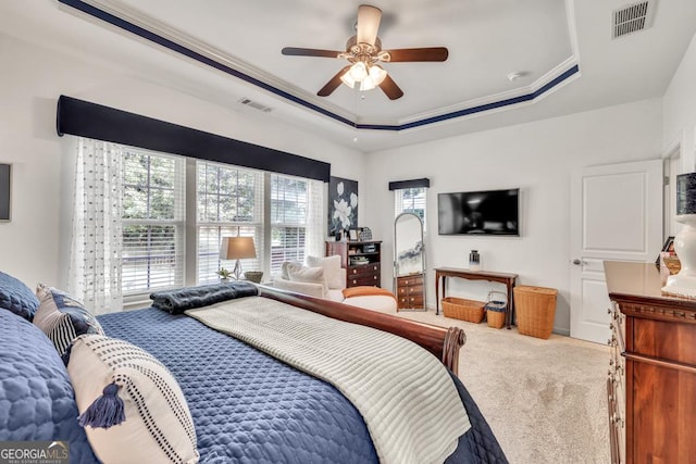 7891 Brass Lantern Dr, Flowery Branch, GA 30542 - carpeted bedroom featuring a tray ceiling, a ceiling fan, and ornamental molding