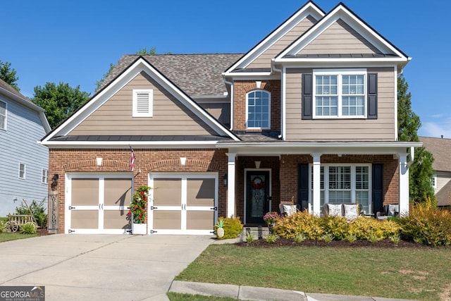 7891 Brass Lantern Dr, Flowery Branch, GA 30542 - craftsman-style house with brick siding, concrete driveway, and a standing seam roof