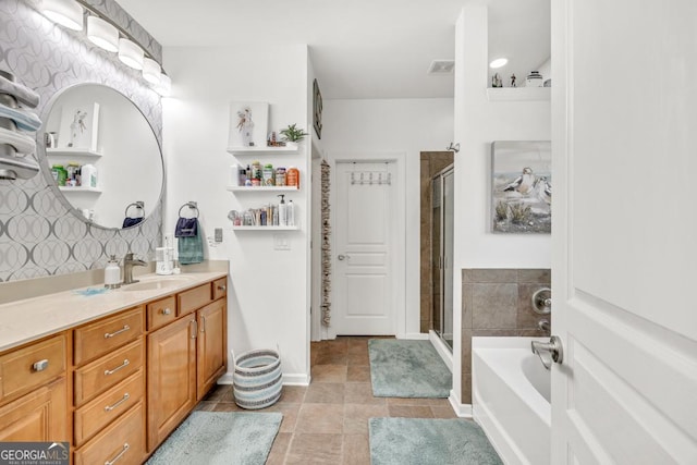 7891 Brass Lantern Dr, Flowery Branch, GA 30542 - bathroom featuring vanity, a stall shower, a bath, and tile patterned floors