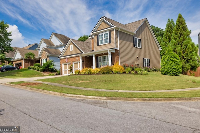 7891 Brass Lantern Dr, Flowery Branch, GA 30542 - traditional home featuring brick siding, driveway, a front yard, and an attached garage