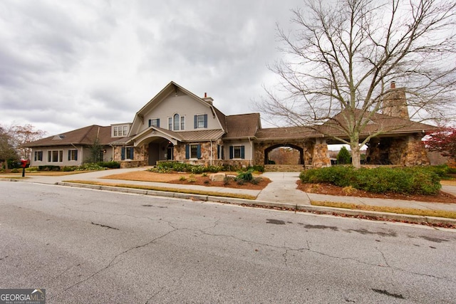 7891 Brass Lantern Dr, Flowery Branch, GA 30542 - dutch colonial featuring stone siding, a chimney, and a gambrel roof