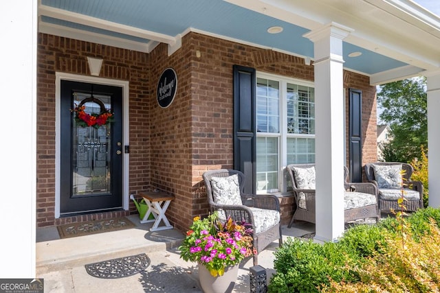 7891 Brass Lantern Dr, Flowery Branch, GA 30542 - entrance to property featuring a porch and brick siding