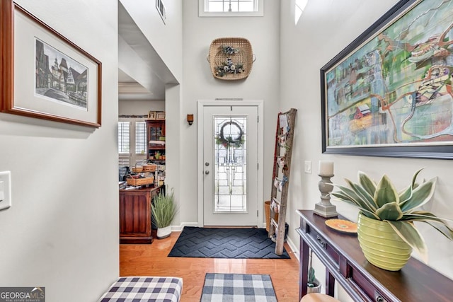 7891 Brass Lantern Dr, Flowery Branch, GA 30542 - entrance foyer with a high ceiling and light wood finished floors
