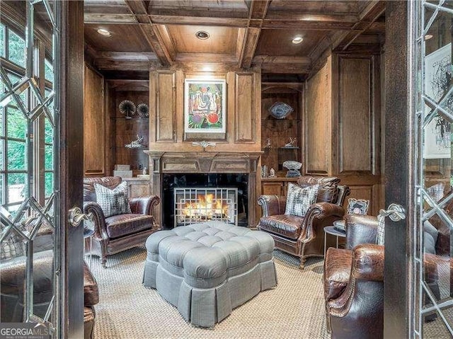 8957 Old Southwick Pass, Johns Creek, GA 30022 - sitting room with wood ceiling with exposed beams, wood walls, ornamental molding, coffered ceiling, and a warm lit fireplace