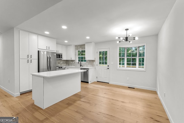 130 Redbud Ct, Senoia, GA 30276 - kitchen featuring appliances with stainless steel finishes, a sink, light countertops, white cabinetry, and recessed lighting