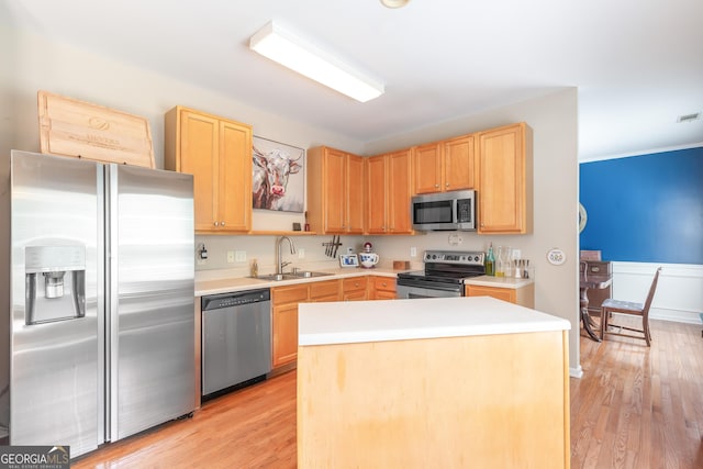 2600 Neighborhood Walk, Villa Rica, GA 30180 - kitchen featuring appliances with stainless steel finishes, light brown cabinets, light countertops, light wood finished floors, and a wainscoted wall