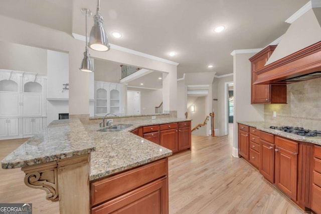 3451 Falls Branch Ct, Buford, GA 30519 - kitchen featuring a sink, stainless steel gas stovetop, crown molding, premium range hood, and tasteful backsplash
