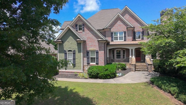 3451 Falls Branch Ct, Buford, GA 30519 - craftsman-style home featuring covered porch, a front lawn, and brick siding