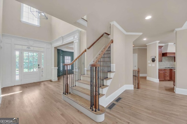 3451 Falls Branch Ct, Buford, GA 30519 - foyer featuring ornamental molding, light wood finished floors, plenty of natural light, stairway, and recessed lighting