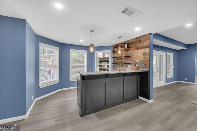 3451 Falls Branch Ct, Buford, GA 30519 - kitchen with baseboards, a peninsula, recessed lighting, wood finished floors, and pendant lighting