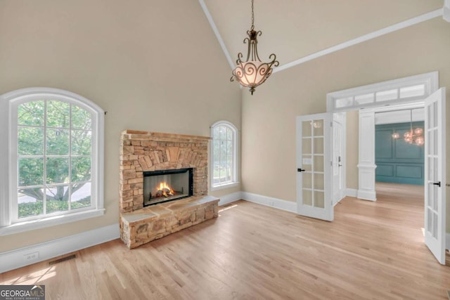 3451 Falls Branch Ct, Buford, GA 30519 - unfurnished living room with french doors, high vaulted ceiling, plenty of natural light, light wood-type flooring, and baseboards