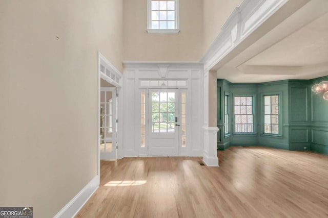 3451 Falls Branch Ct, Buford, GA 30519 - entryway featuring a decorative wall, wood finished floors, a high ceiling, and baseboards