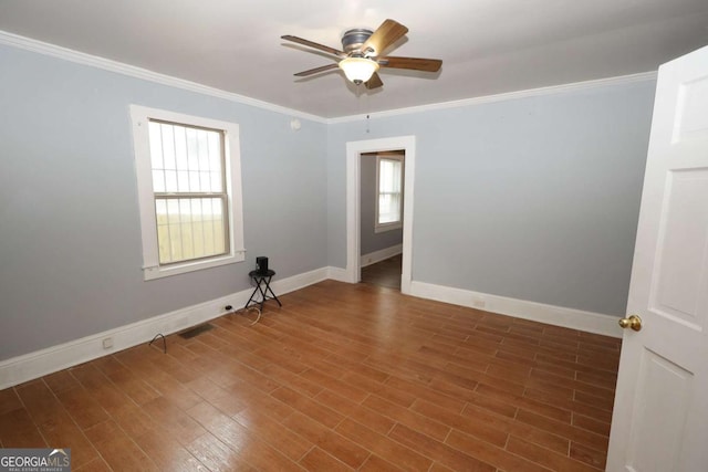 1852 E Farris Ave, Atlanta, GA 30344 - empty room featuring ceiling fan, healthy amount of natural light, baseboards, ornamental molding, and wood finished floors