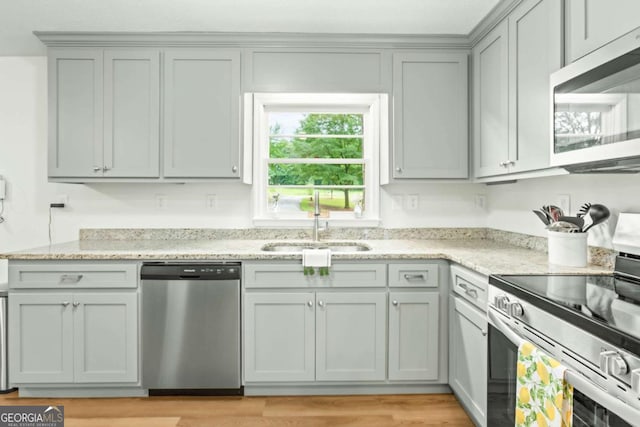 764 Sandy Cross Rd, Lexington, GA 30648 - kitchen featuring appliances with stainless steel finishes, light stone counters, gray cabinetry, and light wood-style flooring