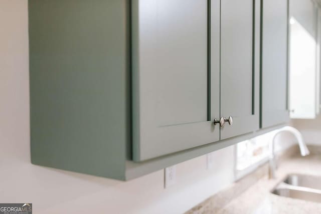 764 Sandy Cross Rd, Lexington, GA 30648 - detailed view of a sink, light countertops, and white cabinets