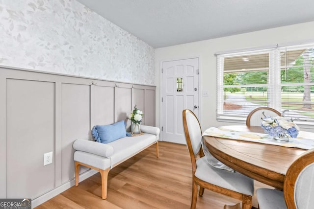 764 Sandy Cross Rd, Lexington, GA 30648 - dining space with light wood-type flooring, a decorative wall, wainscoting, and wallpapered walls
