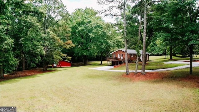764 Sandy Cross Rd, Lexington, GA 30648 - view of green lawn featuring driveway, a wooden deck, and view of wooded area