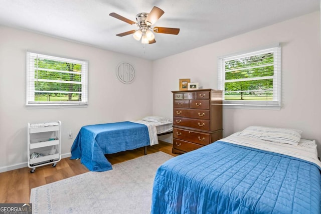 764 Sandy Cross Rd, Lexington, GA 30648 - bedroom with wood finished floors, a ceiling fan, baseboards, and heating unit