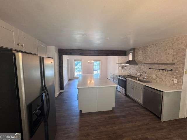 2000 Brickton Sta, Buford, GA 30518 - kitchen featuring appliances with stainless steel finishes, a sink, a chandelier, wall chimney exhaust hood, and dark wood-style flooring